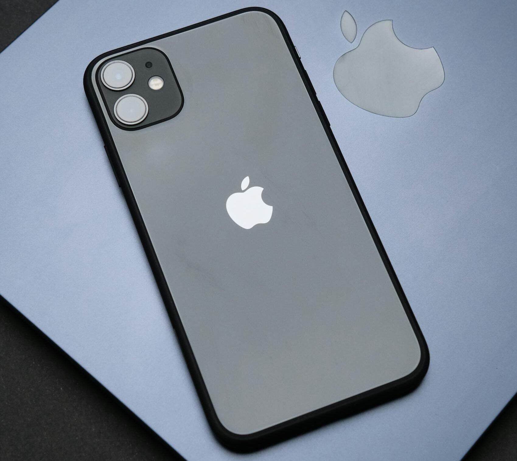 Stylish Apple iPhone on a MacBook, showcasing modern technology and design.